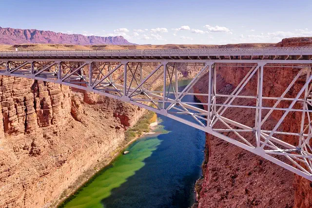 A steel arch bridge over a river canyon.